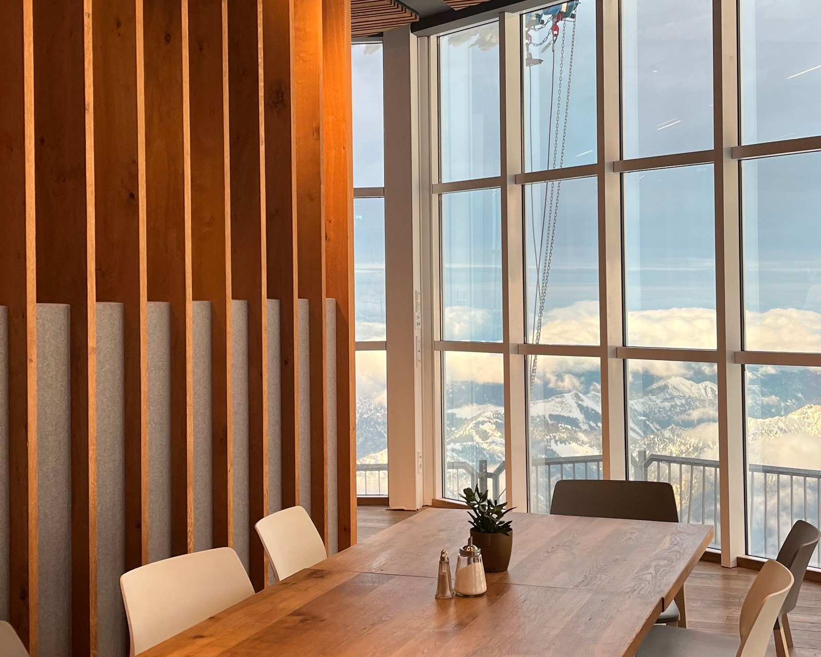 A modern boardroom with a long table and floor-to-ceiling windows